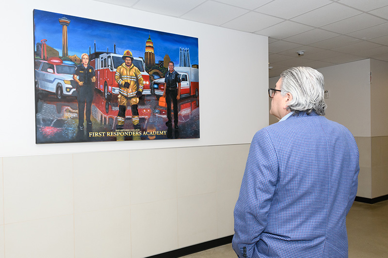 SAC President Solis looks at FRA art.